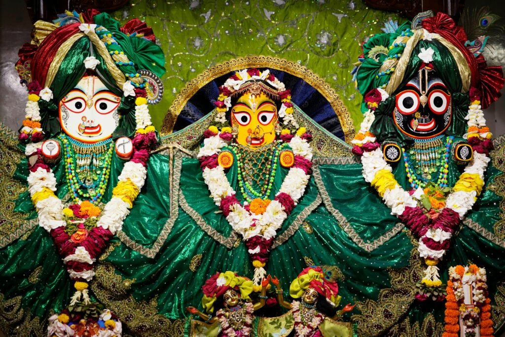 Vibrant display of deity statues adorned in traditional attire at ISKCON, Dhaka.